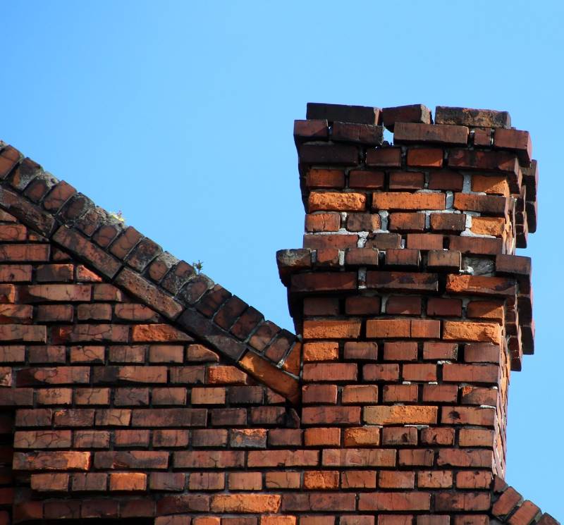 Damaged chimney on an Rockville home showing cracks and missing mortar